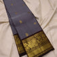 Handwoven Kanchi Pattu Butta saree combining a quiet shot-colour body and ornate peacock pallu