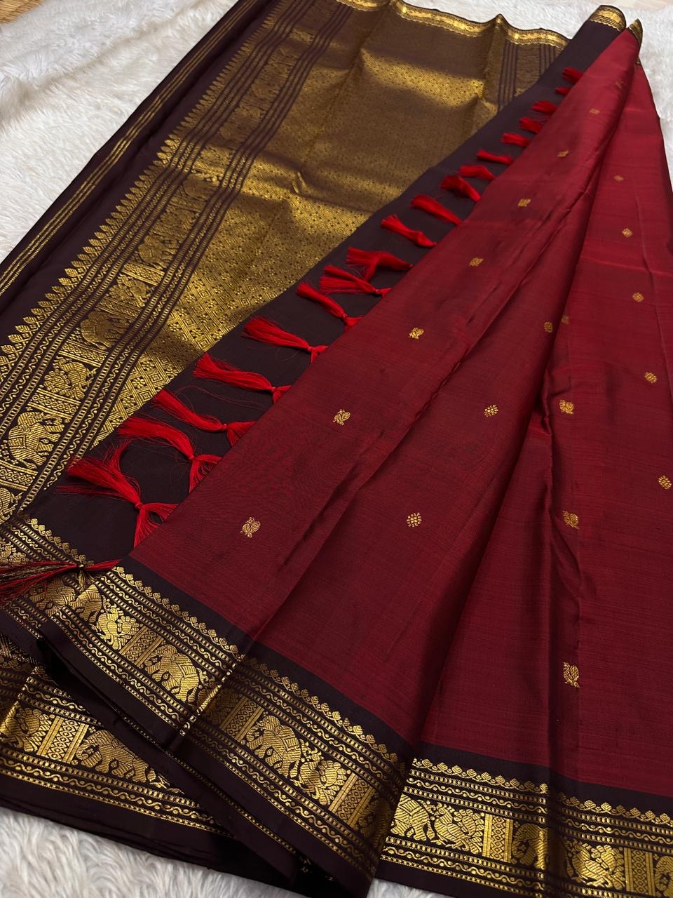 Ember ✨
Pure Kanchipuram Silk Saree in Ember Red & Coffee Brown
Ember-red body with delicate gold zari buttas
Rich coffee-brown elephant border with zari vines

Silk Mark Certified, delivery in 2 weeks