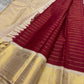 Draped view showing red striped pleats, ivory panel and lustrous gold temple border in Kanchipuram silk