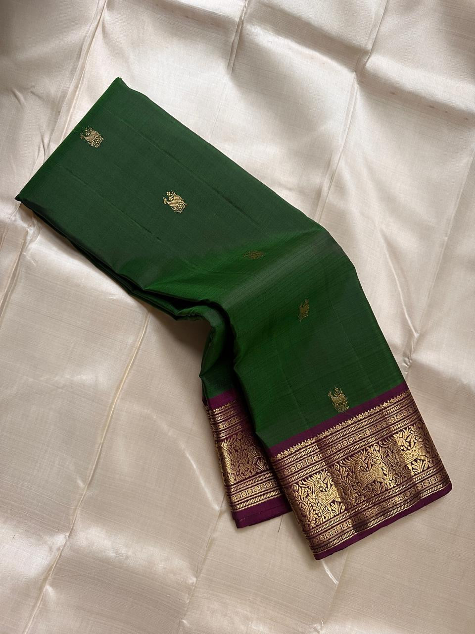 Emerald Plum Maankutti Butta — Pure Kanchipuram Silk Saree
Emerald green body with golden maankutti motifs and a plum korvai border woven in rich zari grandeur.
Silk Mark Certified • Free Shipping within USA • Ships in Two Weeks ✅