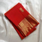 Red Kanchipuram silk saree with gold peacock buttas and rich gold zari border, pure handloom silk.
