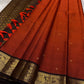 Mantra – Rust brown with coffee brown Kanchipuram Silk Saree with zari Checks with small buttas all over and Antique Peacock zari Border  showcasing regal peacocks and floral vines. A richly detailed pallu completes this heritage Zari kattam