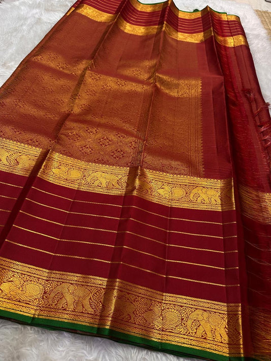 Pure silk kanchipuram maroon Zari  kattam  with butta rettapet border with Zari stripes intricate pallu with green selvedge “ restocked on demand “