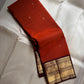 Rust Annam Butta — Kanchipuram Pure Silk

Rust-orange (semman/rust) body with zari chakram buttas

Deep maroon korvai borders with annam (swan) vine motifs

Lavish maroon-gold zari pallu with temple serrations

Silk Mark Certified | Free Shipping