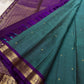 Teal pure Kanchipuram silk saree drape with purple pallu, gold zari woven work, and matching tassels.