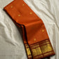 TEJAS – Vibrant Rust Orange Podi Kattam Kanchipuram Silk Saree

Micro-checks body with scattered gold chakram buttas; rich contrast maroon korvai borders

Grand circular annapakshi medallions in lustrous zari; ornate-jaal pallu & tassels

Silk Mark