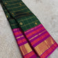 Emerald Blossom ✨ – Pure Kanchipuram Silk Saree
Bottle-Emerald Green Body with Zari Checks & Buttas
Korvai Rani-Pink & Purple Contrast Border with Rich Zari
Grand Rani-Pink Brocade Pallu with Temple motifs , Silk Mark Certified, delivery in 2 weeks