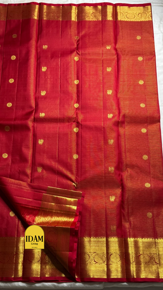 Nakshatra – Radiant Red Vairaoosi Kanchipuram Silk Saree Adorned with Mayil & Chakram Zari Buttas, Featuring an Ornate Kamalam and Floral Vine Zari Border, Flanked by Varisaipet Motifs, and a Pallu Woven with Sacred Thulasi Madams and Regal Kamalams