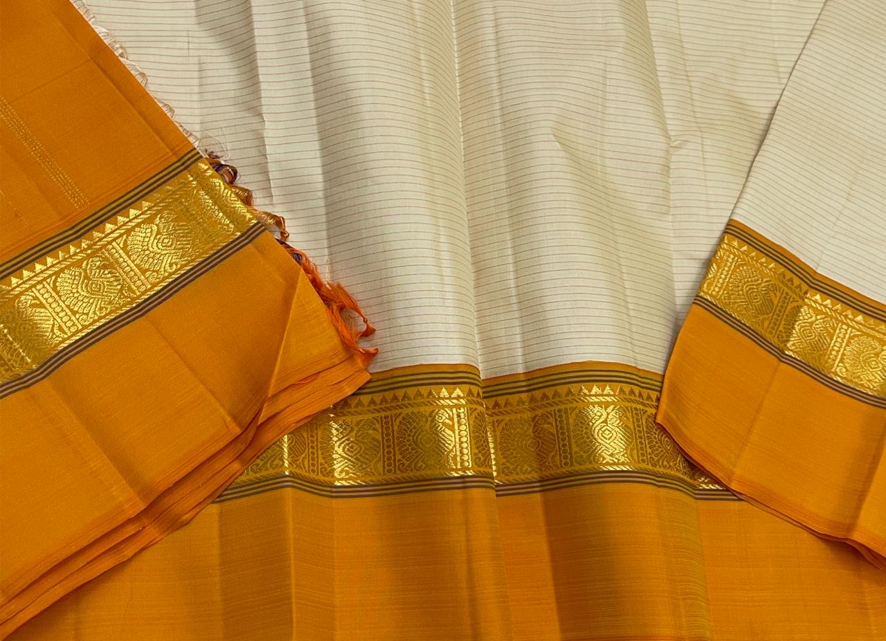 Sweta Kanakam Kattam — Pure Kanchipuram Silk Saree
Ivory Pinstripes × Marigold border with Antique-Gold Zari Border
Silk Mark Certified • Free Shipping within USA • Ships in Two Weeks