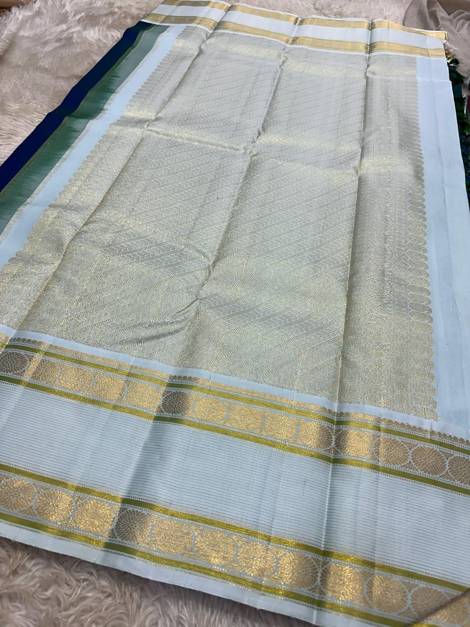 Mayil Kazhuthu ✨ – Peacock’s Neck Kanchipuram Pure Silk Saree
Korvai Royal-Purple Border with Peacock & Floral Zari Vines
Body Embellished with Gold Kamalam (Lotus) Buttas
Grand Gold Zari Pallu with Traditional Motifs & Hand-knotted Tassels
Silk Mark