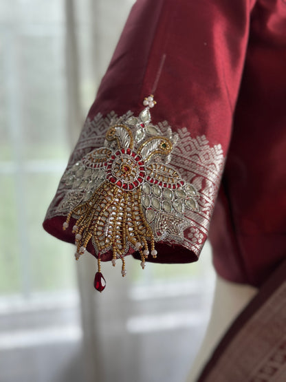 Maroon silver and gold Saree with peacock motif embroidery embellished with temple jewelry style stone work