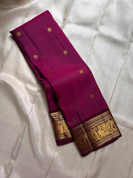 Mythili – Deep Pink Kanchipuram Silk Saree with Kamalam Buttas
Intricately woven with Vanasringaram motifs in a regal brown border
A heritage drape featuring elephants, peacocks & Rudhraksham