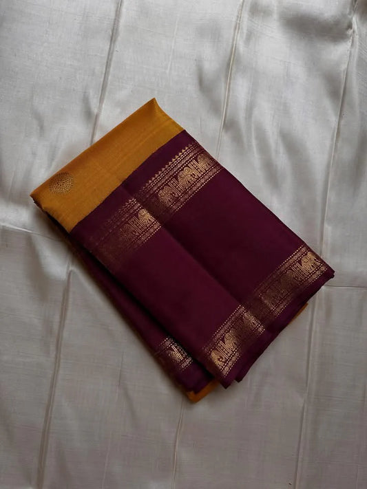 Bhanu – Mustard Gold Handwoven Kanchipuram Silk Saree with Deep Coffee Brown Borders, Intricate Elephant Motif Zari, and a Grand Temple-Inspired Pallu