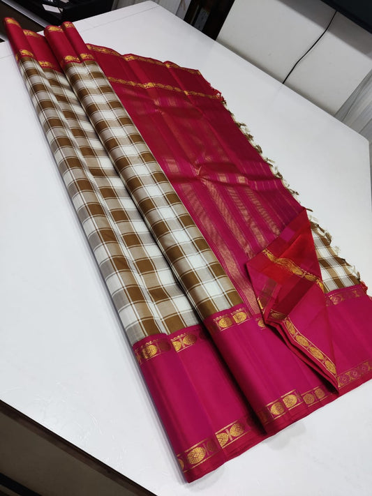 Ivory & Caramel beige Checked Pure Silk Saree

Rani-Pink Rettapet Border with Gold Zari Coin Roundels

Rich Rani-Pink Zari Pallu with Chevron & Stripe Weave

Pink Blouse Piece with Matching Zari Border
silk Mark certified , 2g Zari korvai Kanchipuram