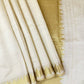 Minimal yet majestic, this ivory-beige silk saree is a celebration of simplicity and sophistication. The body is plain and luminous,  texture of the silk shines through. golden zari border with a sharp, zigzag temple-inspired pattern - perfect for Onam