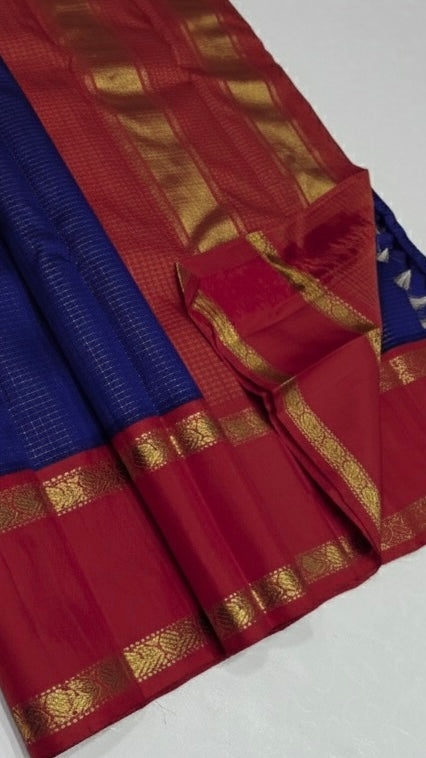 💎 Sapphire Rouge Oosi Kattam — Pure Kanchipuram Silk Saree
Royal sapphire-blue body with fine oosi-kattam checks and contrast rouge-red borders in antique-gold zari
Silk Mark Certified • Free Shipping within USA • Ships in Two Weeks •