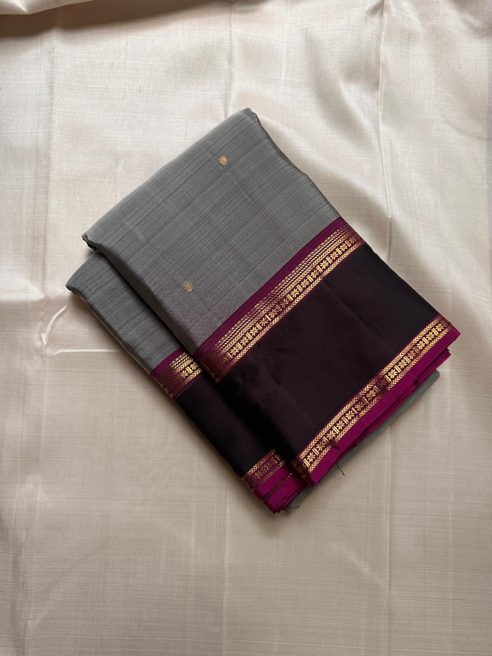 Ash Gulabi Chakram — Pure Kanchipuram Silk Saree
Elegant ash-grey body with gold zari chakram buttas, rich gulabi korvai borders, and deep violet zari pallu.
Silk Mark Certified • Blouse Stitching Available ($30) • Free Shipping within USA • 2 weeks