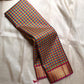 A classic Kanchipuram in Pattani Kattam checks with green, magenta, mustard, and cream.
Finished with a contrast pink border and pallu.
Paisley and chakram motifs in a graceful grid add timeless charm.