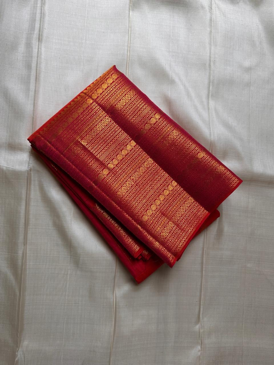 Orange red shot  Zari kattam with ornate border pure silk Kanchipuram with mayil chakram zari butta and detailed Pallu