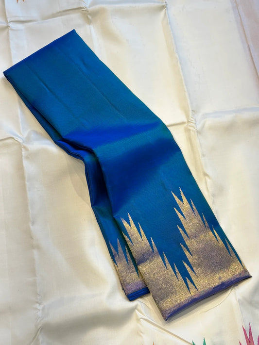 Neelam ettukol 
Pure Kanchipuram Silk Saree – Deep Ocean Blue with Silver Zari Ikat Motifs
Rich 8 Kol Weave for Heavier, Denser & Lustrous Drape
Silver Tissue Pallu with Intricate Brocade Weaving
Includes Matching Blue Blouse Piece with Zari Border