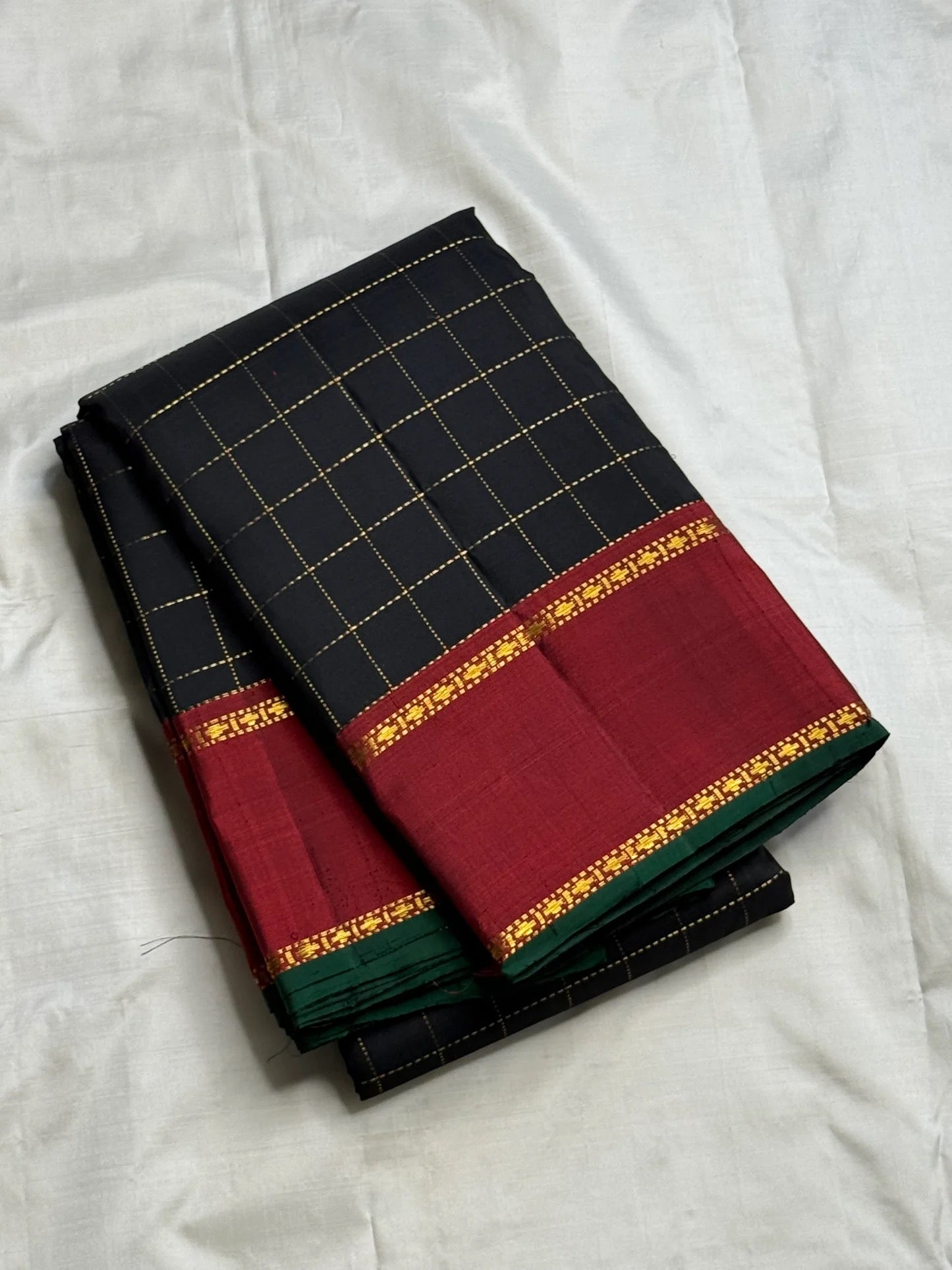 Deep red Kanchipuram pallu with gold zari banding — full spread