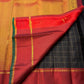 Jet black Kanchipuram saree body with luminous gold zari grid — close-up