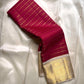 Close-up of red striped pallu and ivory body of Kanchipuram silk saree with gold temple border