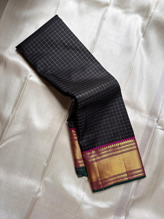 Charcoal Zari Kattam – Pure Kanchipuram Silk Saree
Rich Charcoal Black Body with Gold Zari Checks
Broad Golden Border with Magenta Highlights & Green Selvedge
Royal Magenta Pallu with Lustrous Zari Stripes

Silk Mark Certified, delivery in 2 weeks