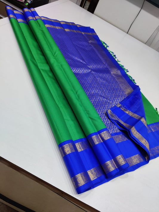 Verdant Sapphire – Pure Kanchipuram Silk Saree
Lush Green Body with Zari Kattam Checks ✨
Royal-Blue Rettapet Border with Gold Zari
Grand Royal-Blue Diamond Brocade Pallu

Silk Mark Certified, delivery in 2 weeks
