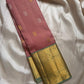 Vahini – Pleasant Peach Pink Pure Kanchipuram Silk Saree with Zari Kattam Checks, Silver & Gold Peacock Buttas, Sage Green Border Adorned with Kamalam Vines and Baavanji Motifs, and an Ornate Zari Pallu with Majestic Peacocks