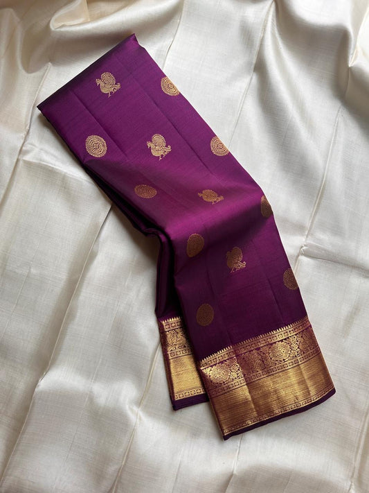 A silk symphony in the deepest shade of plum.mayil chakram butta bavanji border - classic in a stunning color plum pure silk Kanchipuram saree