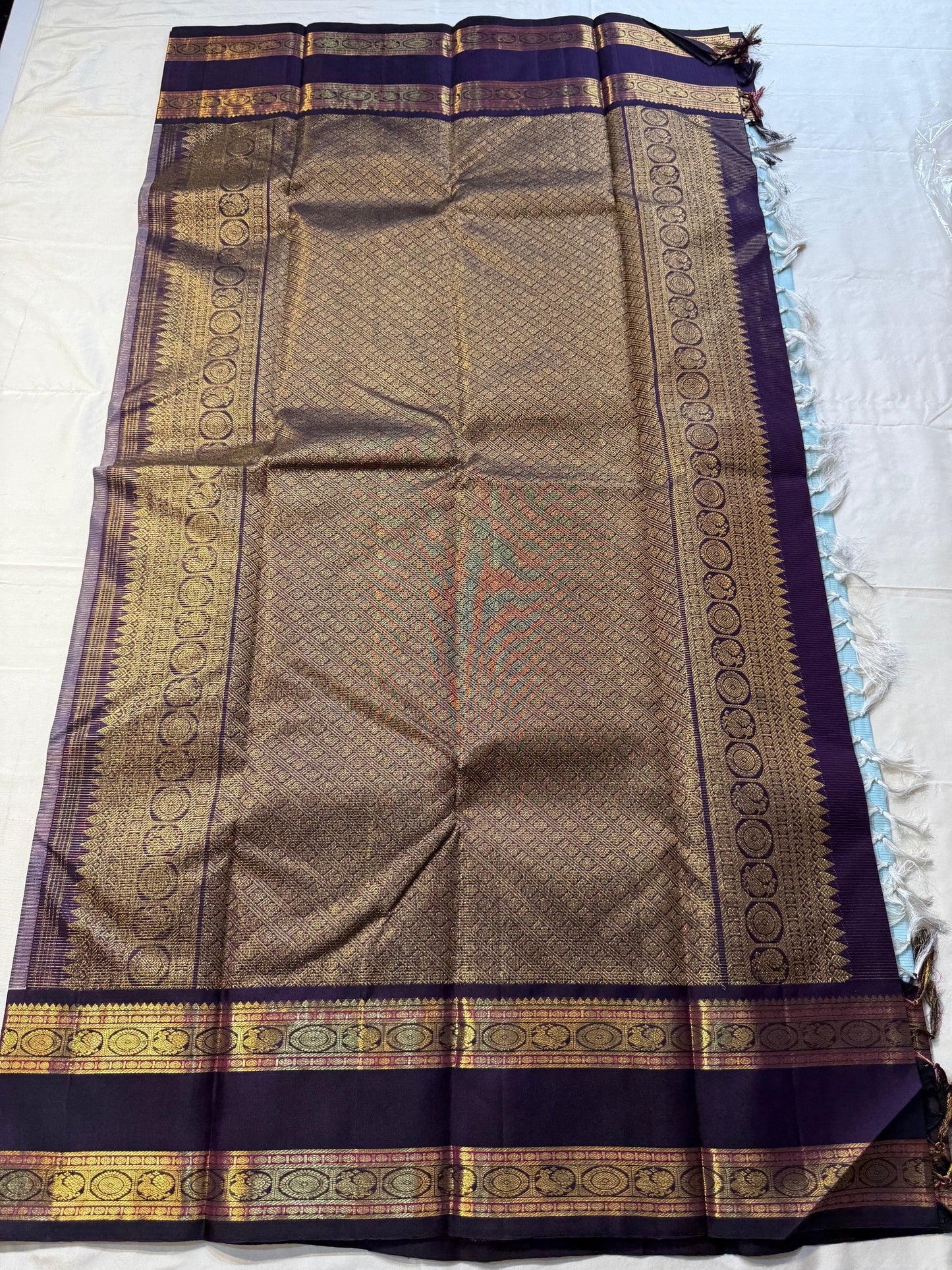 Neel Pushpa – Pure Kanchipuram Silk Saree
Pastel Powder Blue Vairaoosi Weave Body
Deep Violet Korvai Border with Zari Medallions
Antique Gold Zari Brocade Pallu, Diamond Jaal

Silk Mark Certified, delivery in 2 weeks