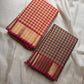 A classic Kanchipuram in Pattani Kattam checks with pink, magenta, mustard, and cream.
Finished with a contrast pink border and pallu.
Paisley and chakram motifs in a graceful grid add timeless charm.