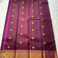 Plum & Magenta Round Butta – Pure Kanchipuram Silk Saree
Deep plum body with bold round gold zari buttas
Contrast green selvedge & gold tissue borders with magenta detailing
Grand magenta-pink pallu with full zari diamond jaal & geometric panels
Silk Mark