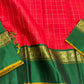 Emerald Ruby Korvai
Pure Kanchipuram Silk Saree – Ruby Red Body with muthu kattam  Grid Checks
Emerald Green Korvai Borders Adorned with Zari Elephant Motifs
Grand Green Zari seer Pallu with Traditional motifs 
Silk mark certified, ships in 2 weeks