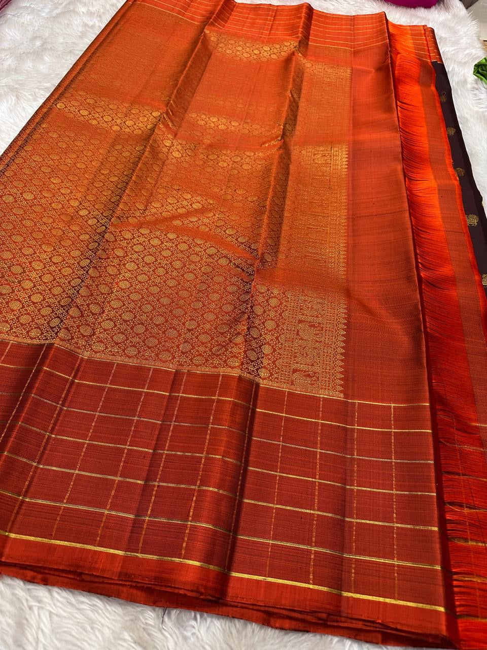 Minmini – Deep brown Pure Kanchipuram Silk Saree with Gold Zari Buttas, Vibrant Orange Checked Border in Zari Kattam Weave & Ornate Gold Brocade Pallu with Traditional Motifs