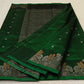 green chanderi silk saree laid flat showing full body and woven border