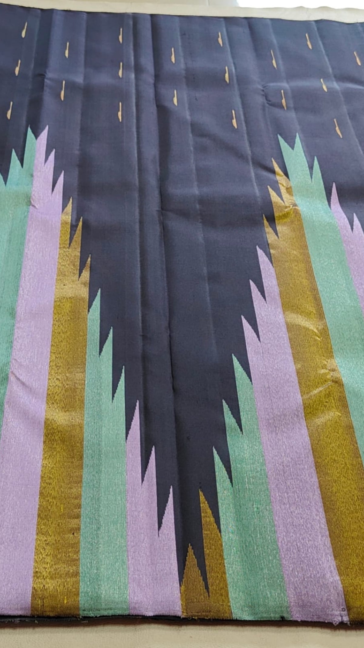 Rich black Ettukol Kanjivaram silk showing the contrast between deep charcoal and soft pastel woven accents.