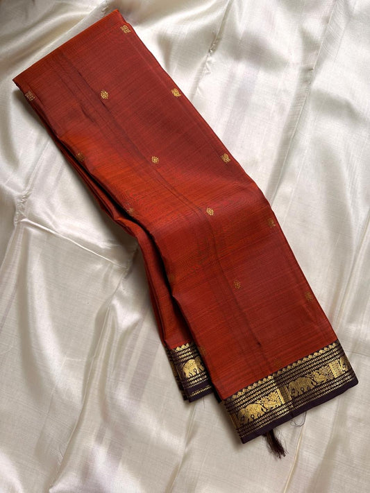Varnam – Rust Brown Kanchipuram Silk Saree with Yazhi & Kamalam Buttas, Petite Elephant Zari Border & Intricately Woven Grid Pallu | Pure Handloom Heritage