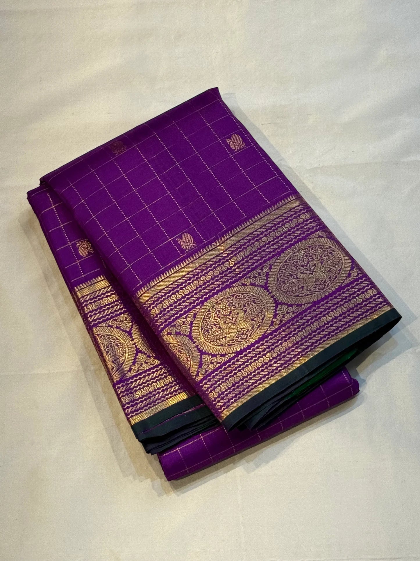 Sunanda – Royal Purple Pure Kanchipuram Silk Saree with Zari Checked Buttas & Majestic Sorgavaasal Mayil Peacock Medallion Temple Border