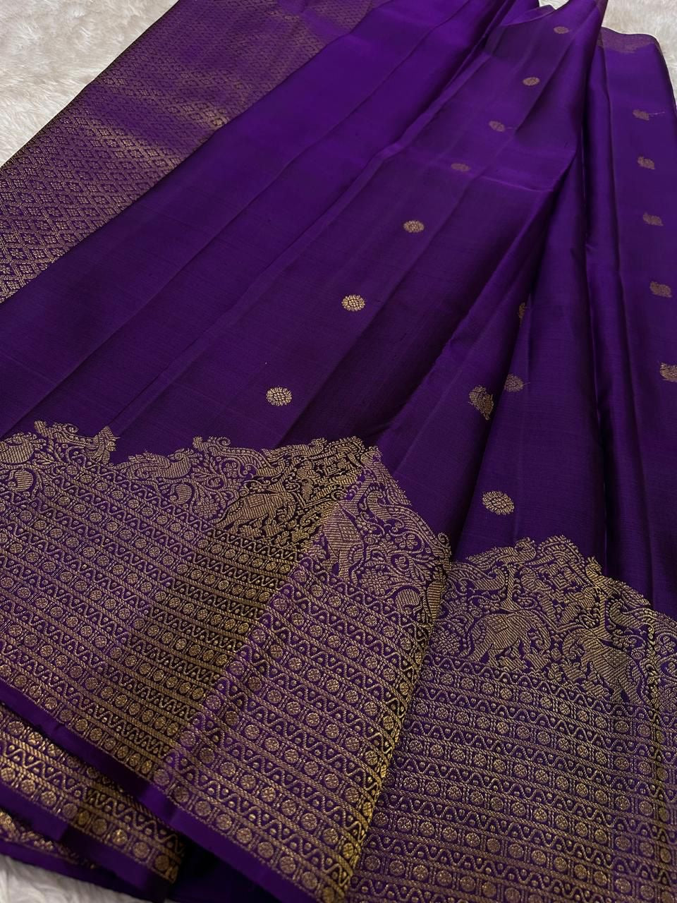 Lotus Glow — Violet | Pure Kanchipuram Silk Saree
A royal violet canvas with antique-gold zari peacocks, elephants & lotus motifs ✨
Silk Mark Certified • Free USA Shipping • Ships in Two Weeks