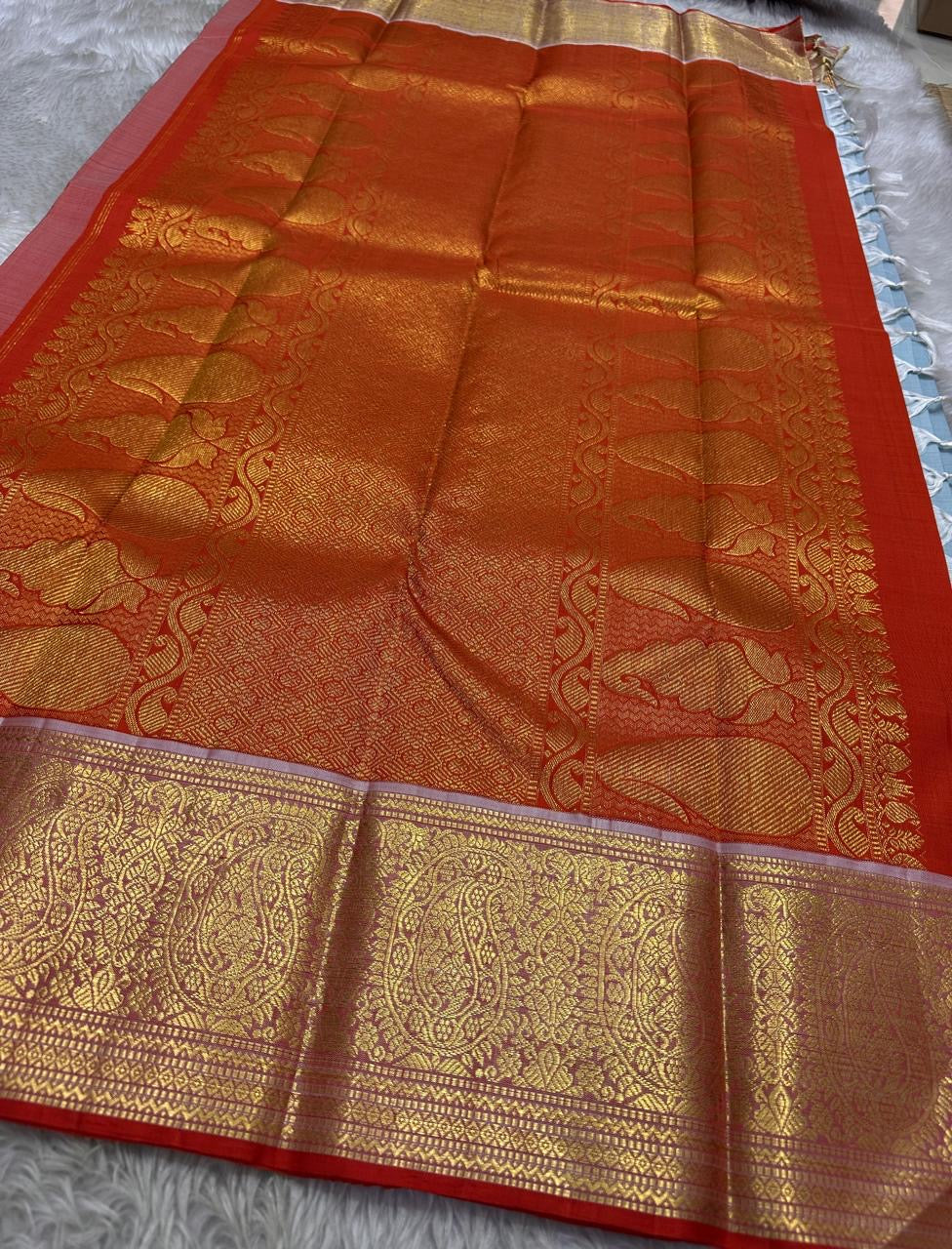 A saree where sky blue melts into sunrise orange—pure silk Kanchipuram magic.