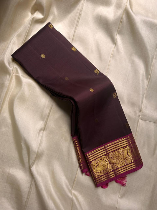 deep coffee brown silk stirred gently with a bold magenta border-  rich drape pure silk mayil chakram butta saree