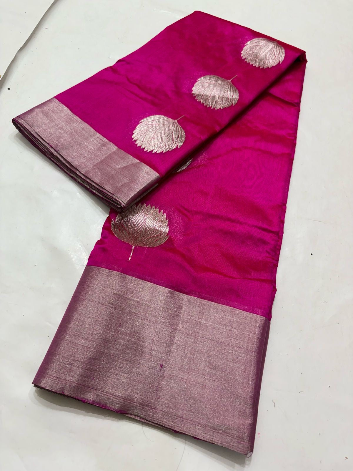 Fuchsia Pink Chanderi Pure Silk Saree with Zari Lotus Buttas and Radiant Gold Pallu
Light as a dream and luminous as morning light, this saree glows in rich fuchsia silk.
Ornate handwoven lotus buttas bloom across the body in fine gold zari.