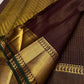 closeup of wide gold zari woven border with green edge on pure kanchipuram silk saree