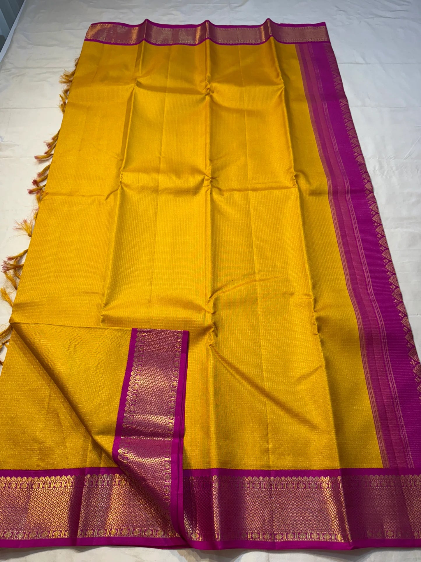 Ambar Rani — Pure Kanchipuram Silk Saree
Amber yellow oosi-kattam checks with contrast rani-pink korvai border and grand zari brocade pallu.
Silk Mark Certified • Free Shipping within USA • Ships in Two Weeks ✅