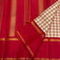 Red silk pallu laid flat with vertical gold zari woven stripes, with the checked cream section and red border folded on top.