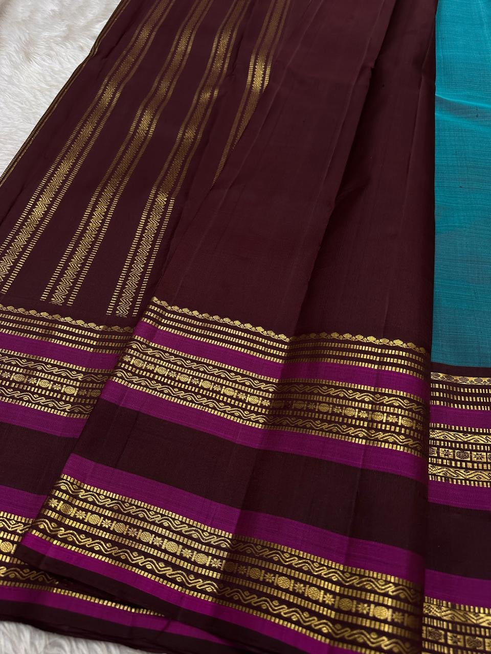 Neelam Jamuna – Pure Kanchipuram Silk Saree

A teal body adorned with glowing zari buttas.

Wine korvai border detailed with antique-gold.

A majestic jamuna pallu rich in brocade artistry.

Silk Mark Certified, delivery in 2 weeks