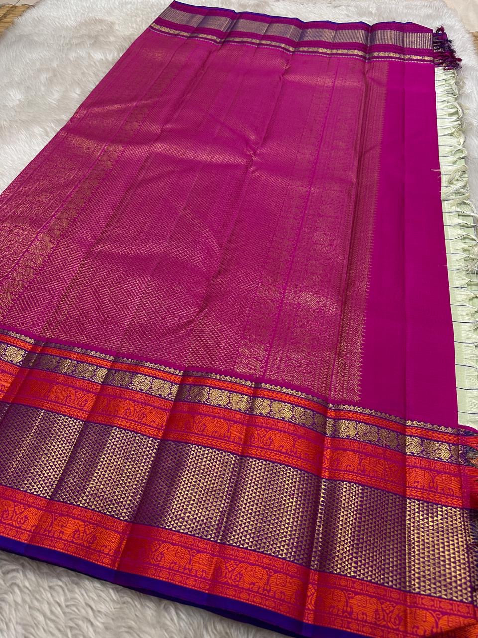 Pastel green pistachio with kungumam red and royal blue border dark blue silk thread checks mayil chakram butta magenta detailed Pallu