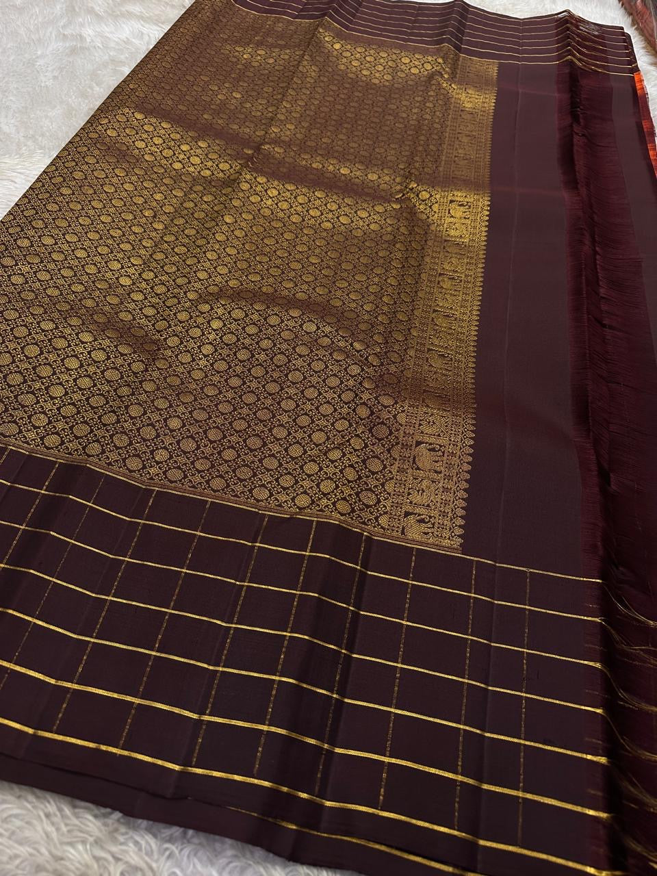 Poornima Kalyani
Burnt Orange & Cocoa Kanchipuram Silk Saree
Zari Buttas · Grid Borders · Silk Mark Certified